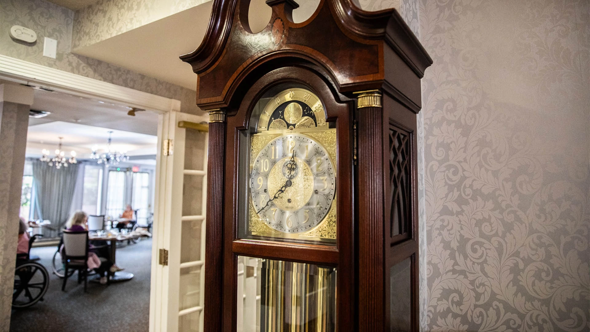 Brown and gold grandfather clock